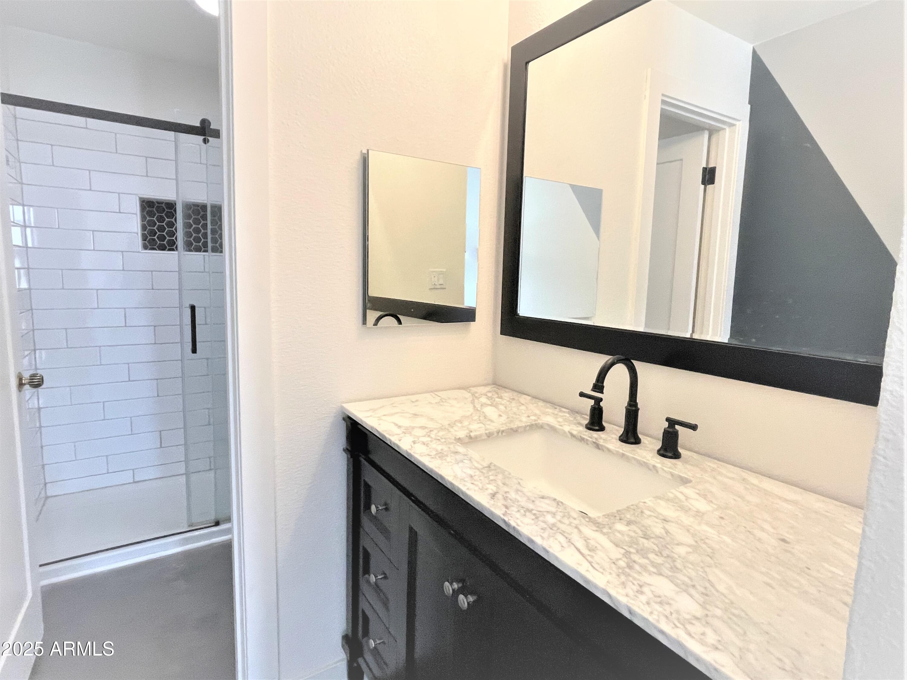 8 West Griswold Road Phoenix, AZ 85021 - Photo 12 of 22 a bathroom with a granite countertop sink and a mirror