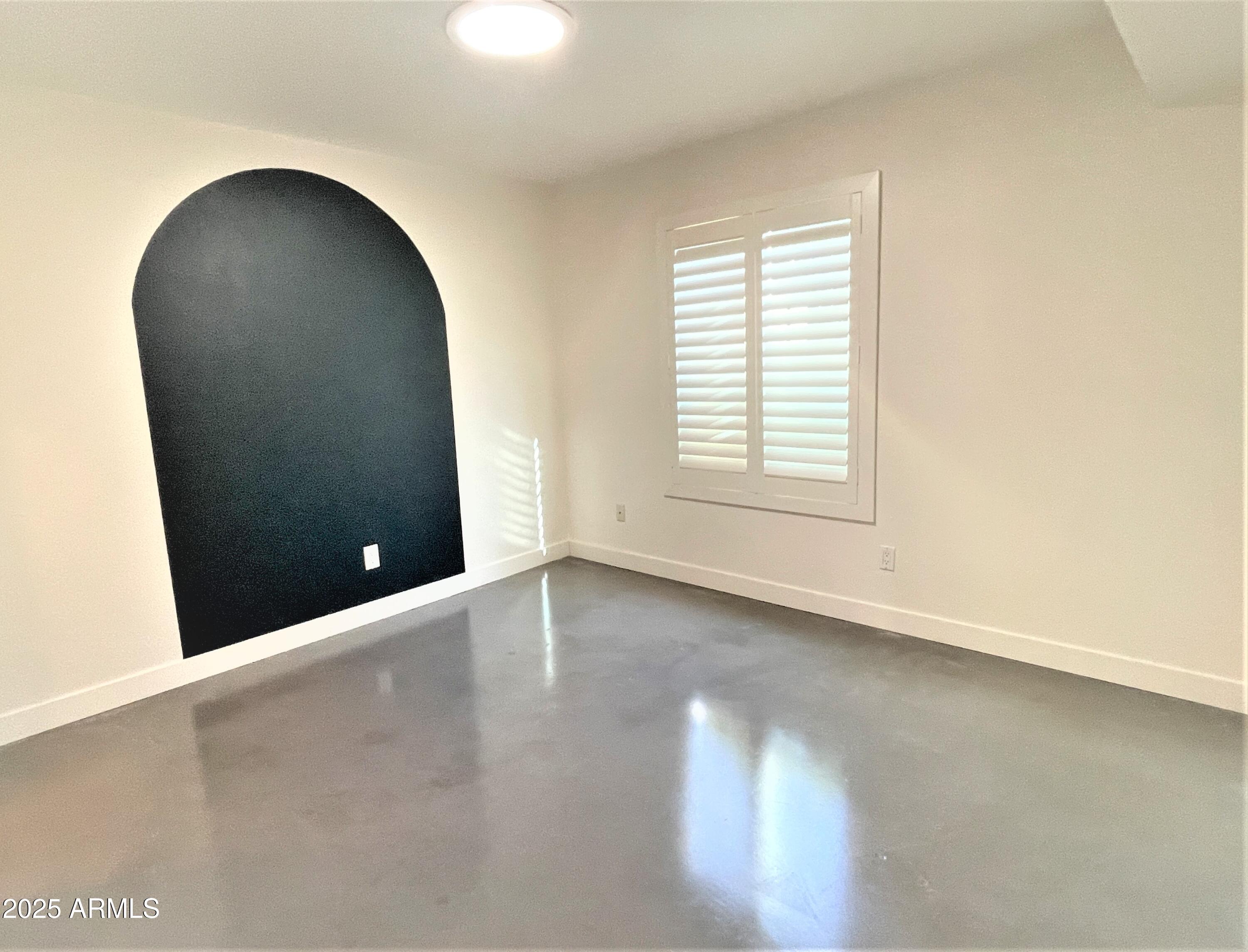 8 West Griswold Road Phoenix, AZ 85021 - Photo 14 of 22 an empty room with wooden floor and windows