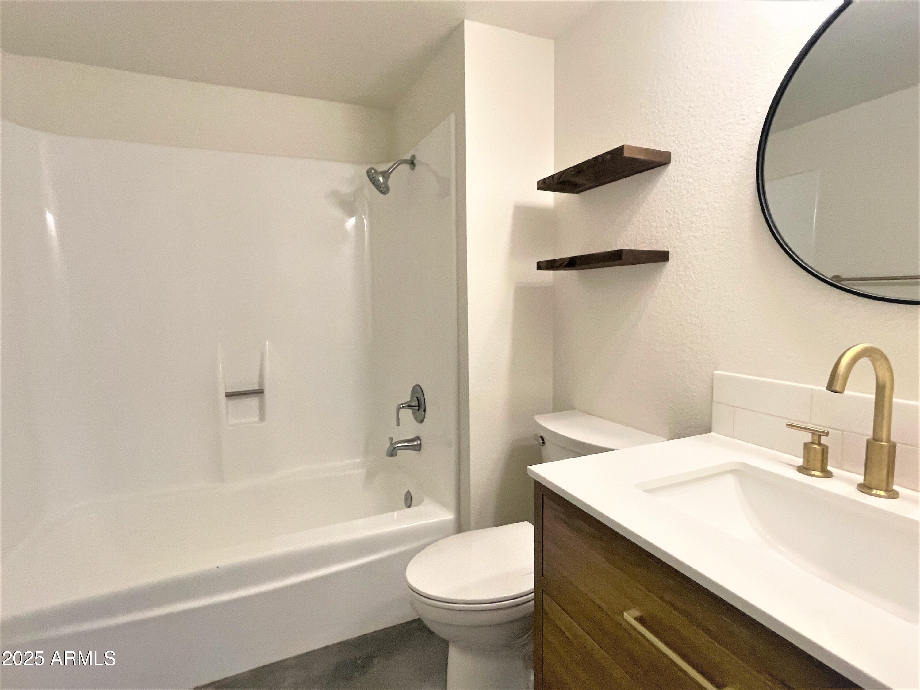 8 West Griswold Road Phoenix, AZ 85021 - Photo 18 of 22 a bathroom with a sink a toilet and a mirror