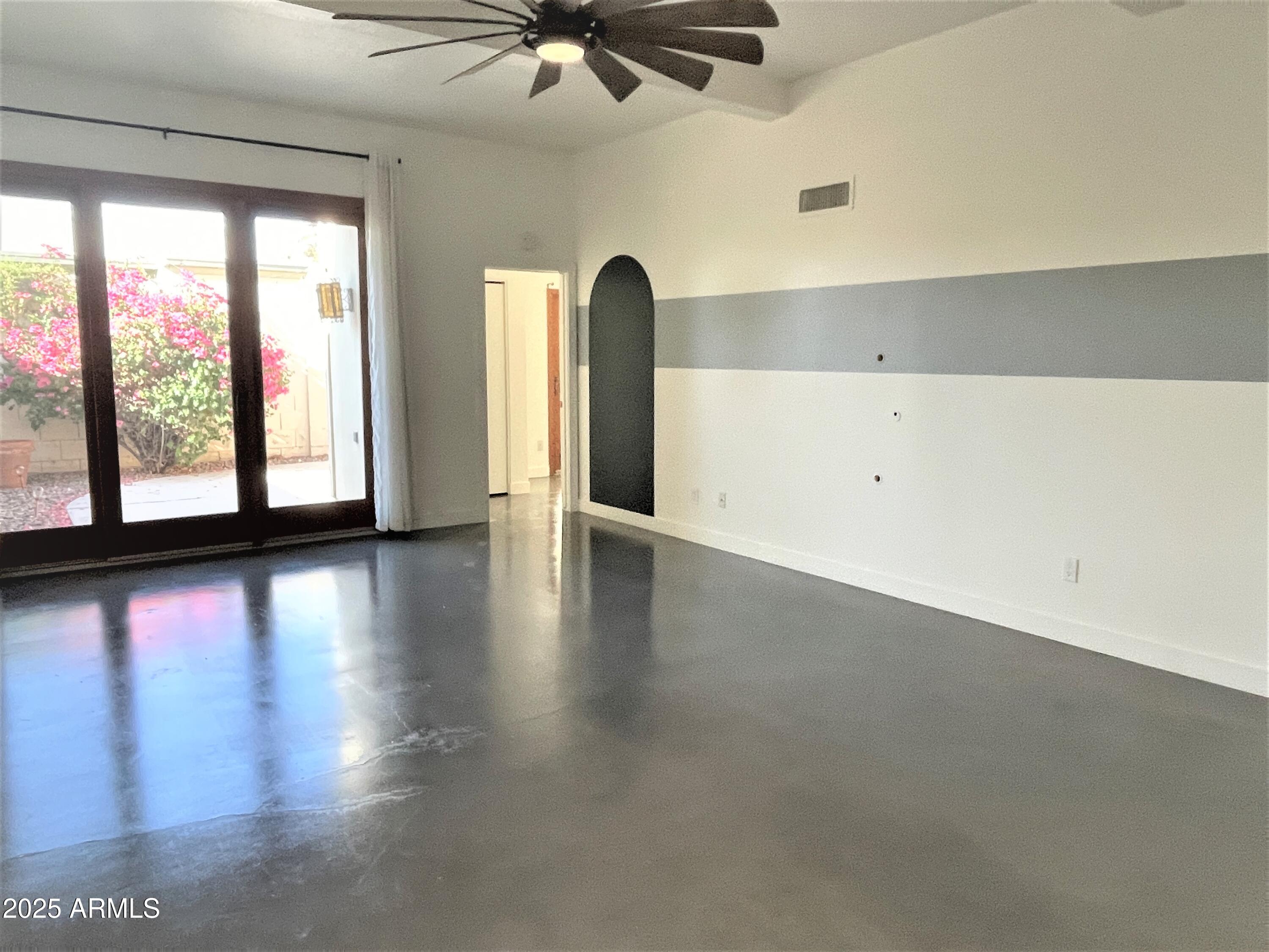 8 West Griswold Road Phoenix, AZ 85021 - Photo 3 of 22 a view of a livingroom with wooden floor and a ceiling fan