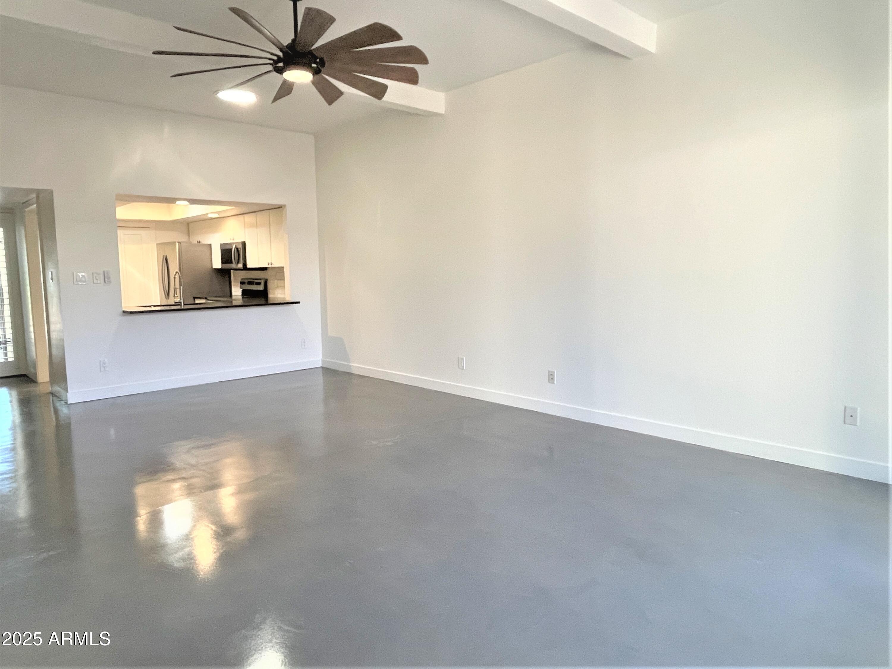 8 West Griswold Road Phoenix, AZ 85021 - Photo 4 of 22 a view of a room with a ceiling fan and a window