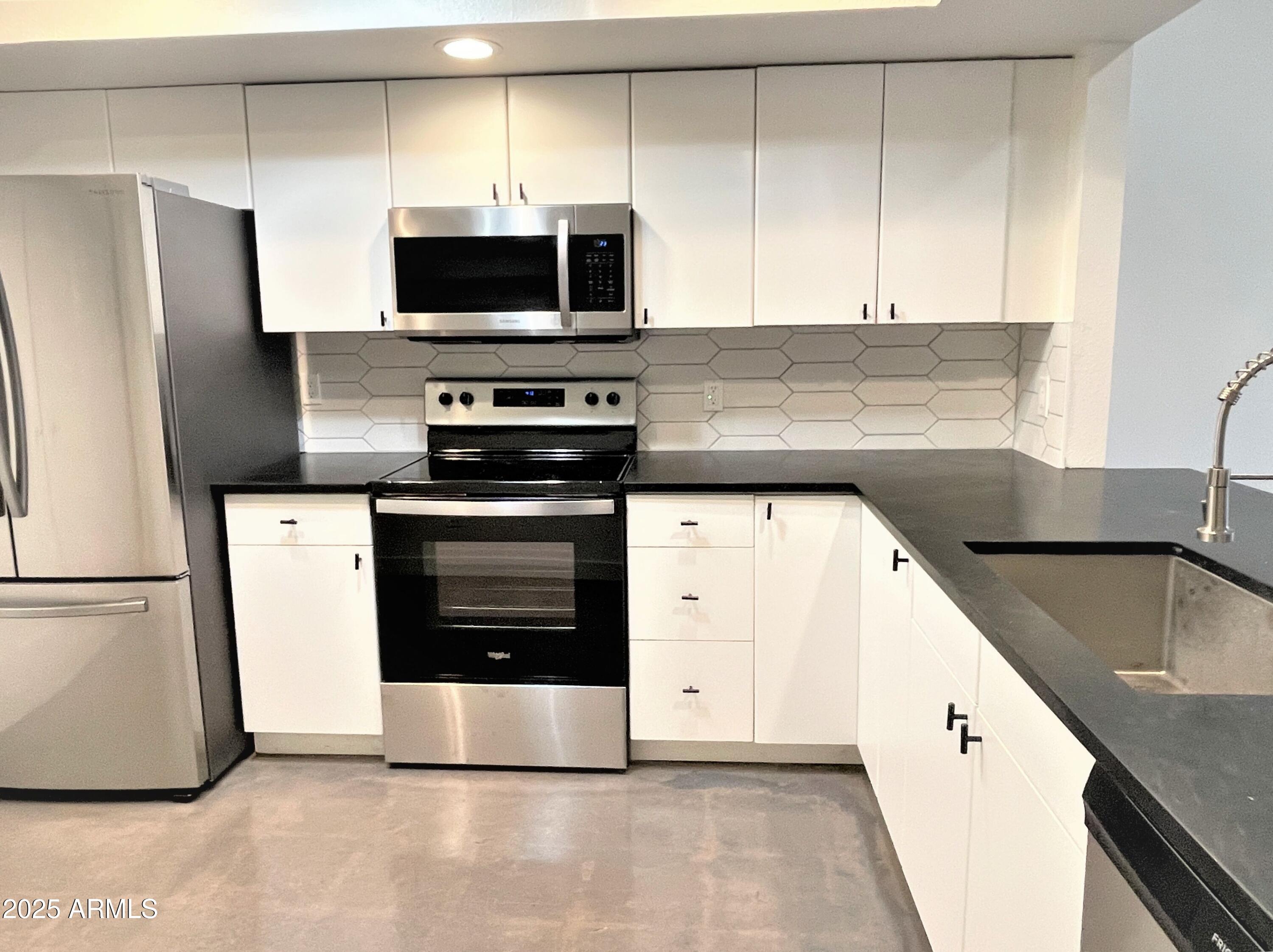 8 West Griswold Road Phoenix, AZ 85021 - Photo 8 of 22 a kitchen with stainless steel appliances a stove a sink and a microwave