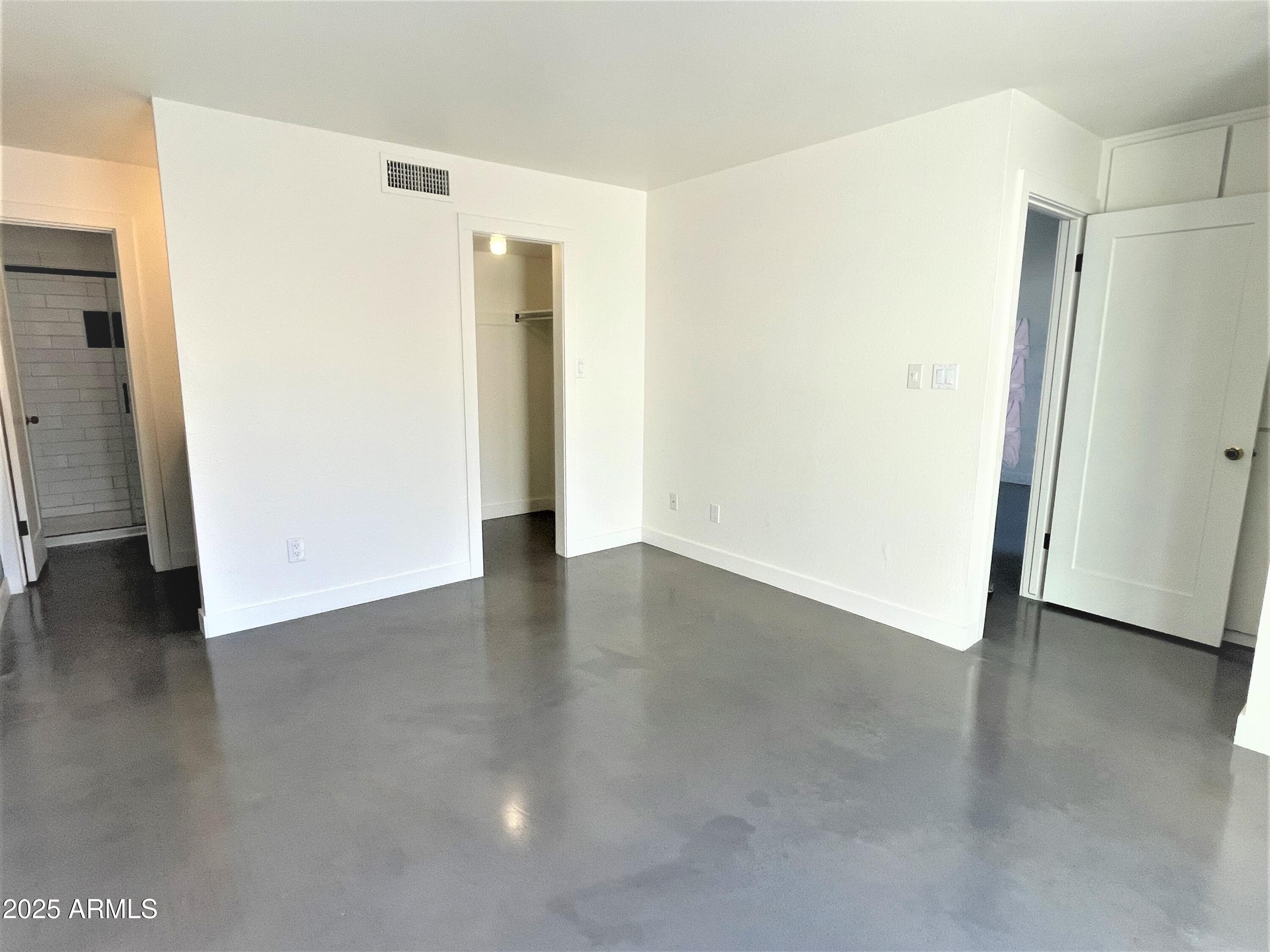 8 West Griswold Road Phoenix, AZ 85021 - Photo 10 of 22 a view of an empty room with wooden floor and a window