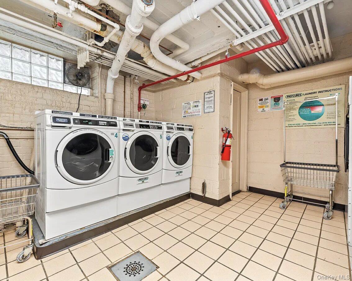 102-25 67th Road, Unit 4C Queens, NY 11375 - Photo 14 of 16 a utility room with dryer and washer