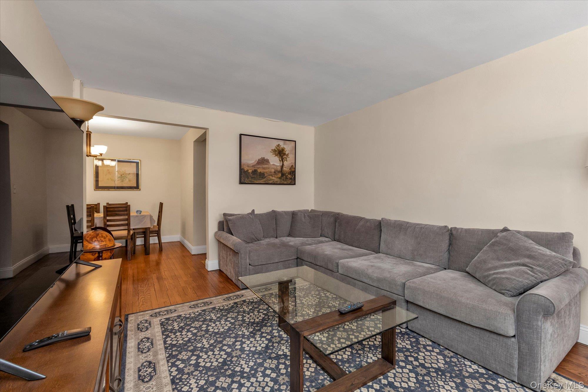 102-25 67th Road, Unit 4C Queens, NY 11375 - Photo 4 of 16 a living room with furniture and a couch