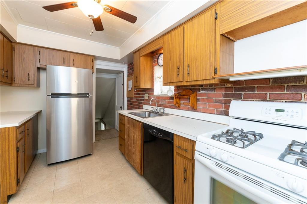 451 Ohio Avenue Rochester, PA 15074 - Photo 8 of 17 a kitchen with stainless steel appliances granite countertop a refrigerator a stove and a sink