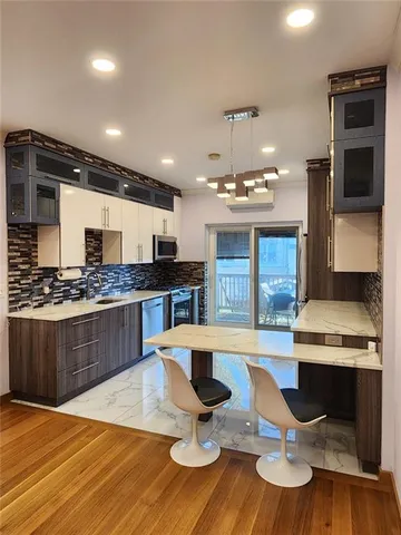 a large kitchen with a table and chairs