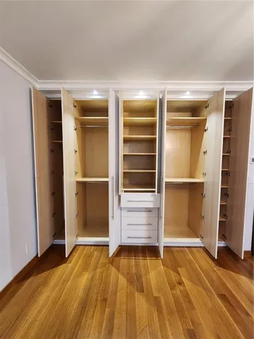 a view of an empty room with a chandelier fan