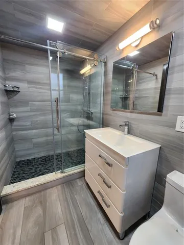 a bathroom with a shower and a sink