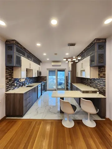 a large kitchen with lots of counter space and stainless steel appliances