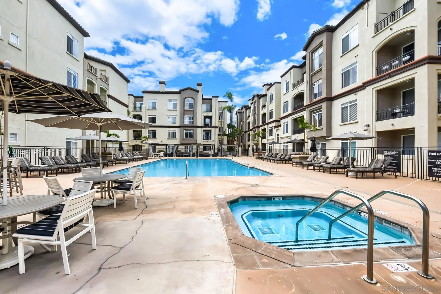 9293 Regents Road, Unit C108 La Jolla, CA 92037 - Photo 12 of 14 a view of a swimming pool with a lounge chairs