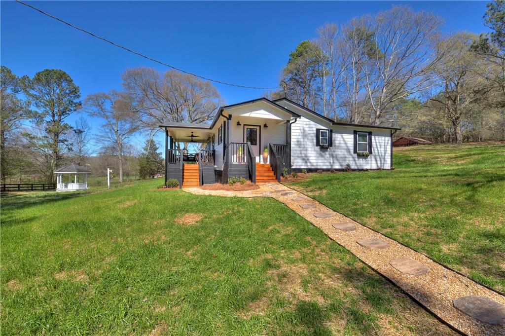 150 Hall Station Road Kingston, GA 30145 - Photo 1 of 1 a front view of a house with garden