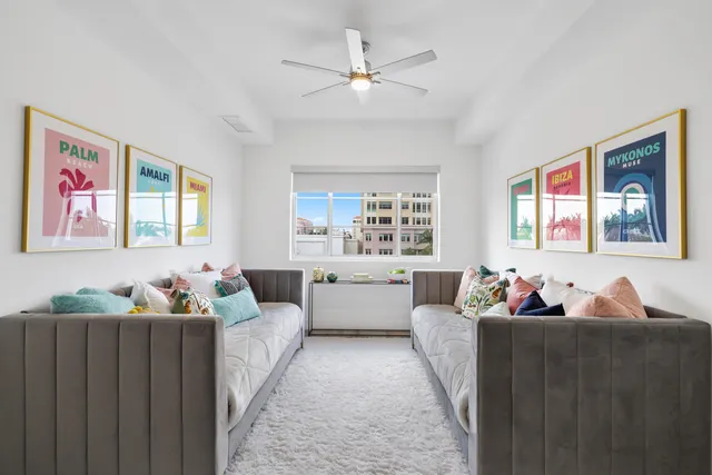 a living room with furniture and wall painting
