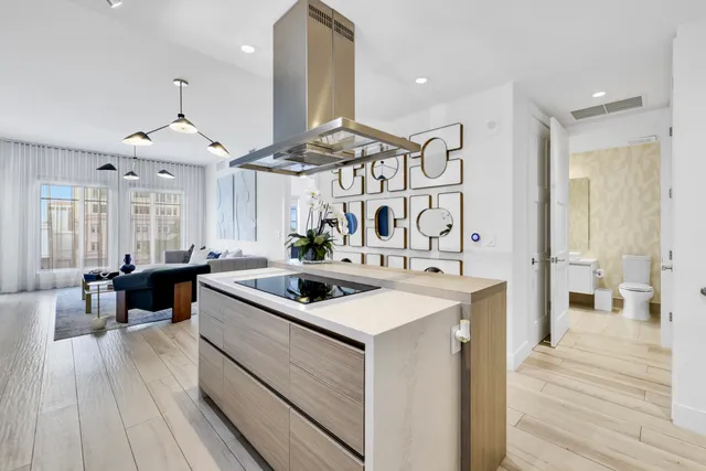 a kitchen with a sink stove and wooden floor