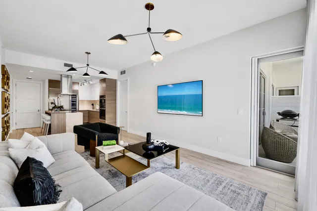 a living room with furniture and a chandelier