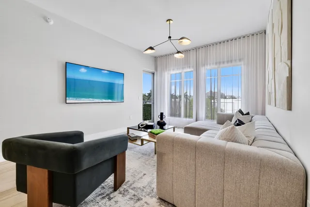 a living room with furniture and a large window