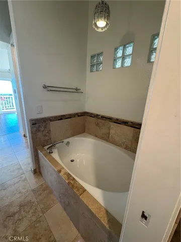 a bath tub sitting next to a shower