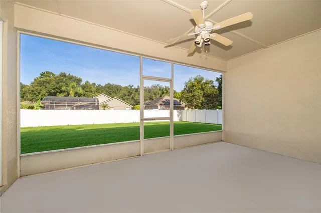 a view of a room with a ceiling fan and a yard
