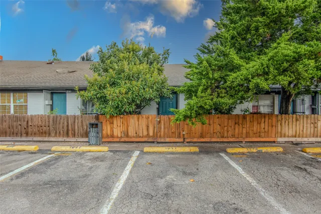 a view of small house with wooden fence