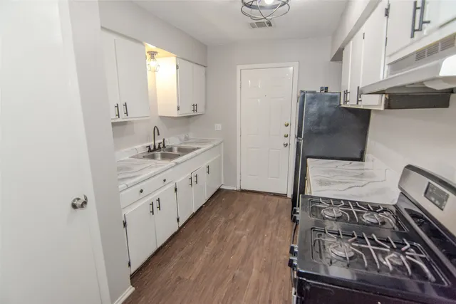 a kitchen with stainless steel appliances granite countertop a stove and a refrigerator