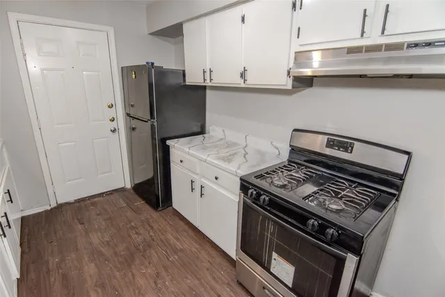 a kitchen with a stove and a refrigerator