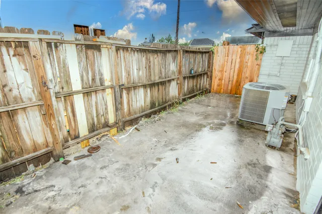 a view of a backyard with wooden fence