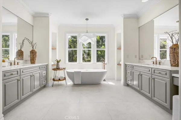 a spacious bathroom with a large tub sink and window