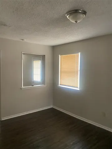 an empty room with wooden floor closet and chandelier fan