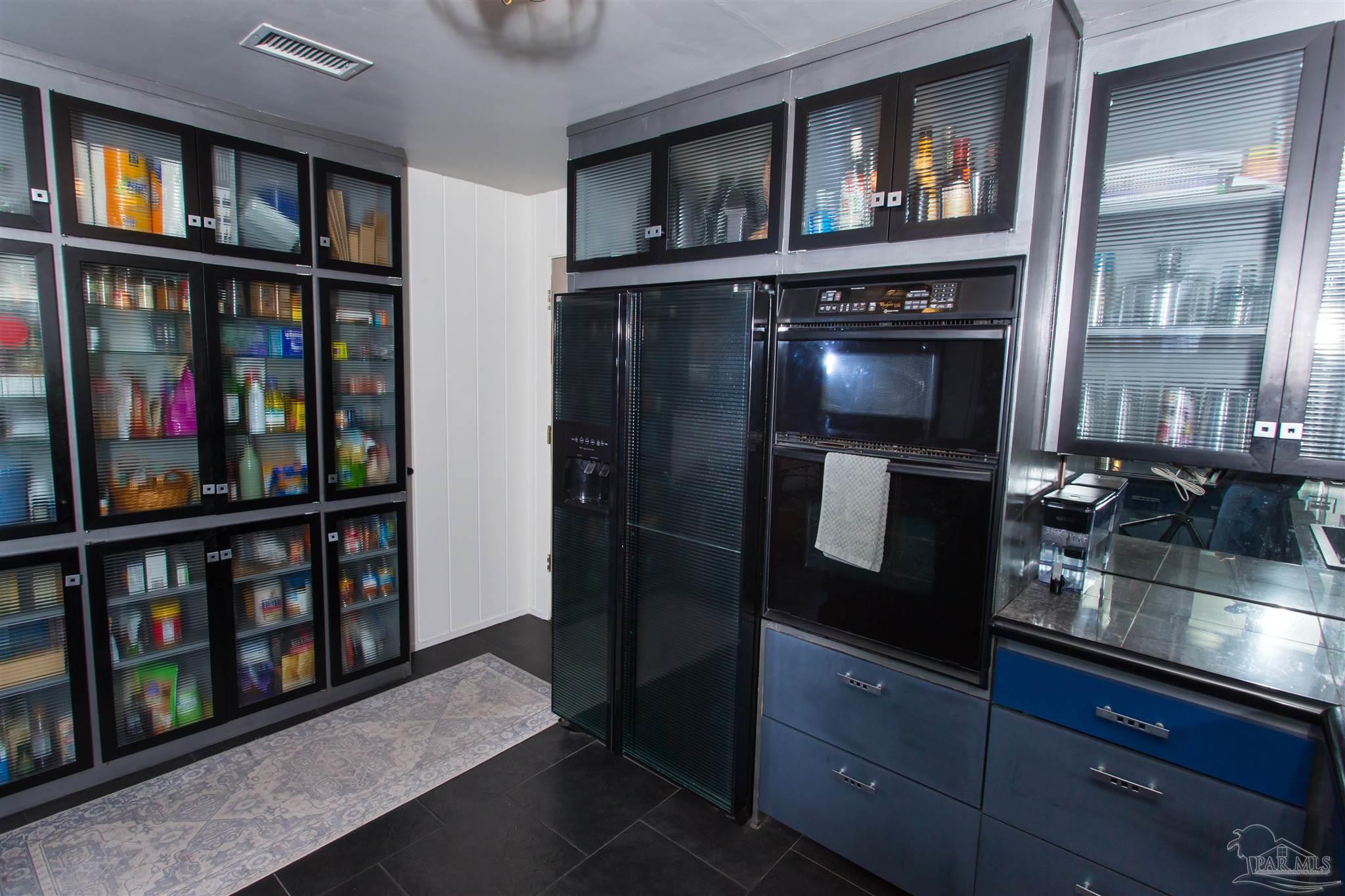 4415 Piedmont Road Pensacola, FL 32503 - Photo 11 of 43 a kitchen with stainless steel appliances granite countertop a refrigerator and a wooden floor