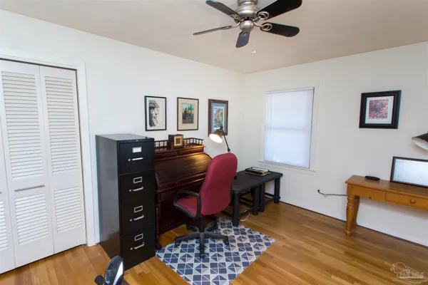 a view of a workspace with furniture and a window