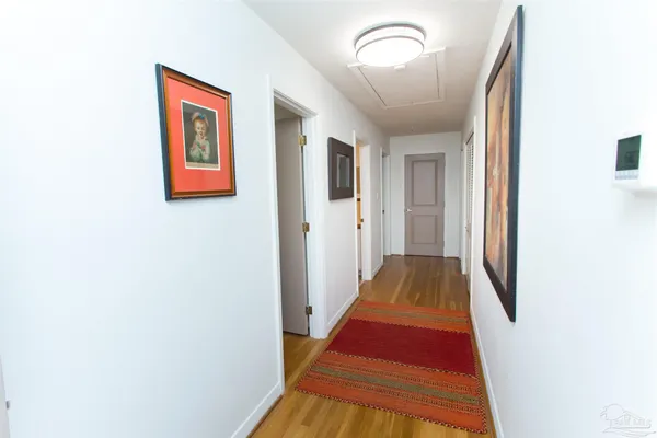 a view of a hallway with wooden floor
