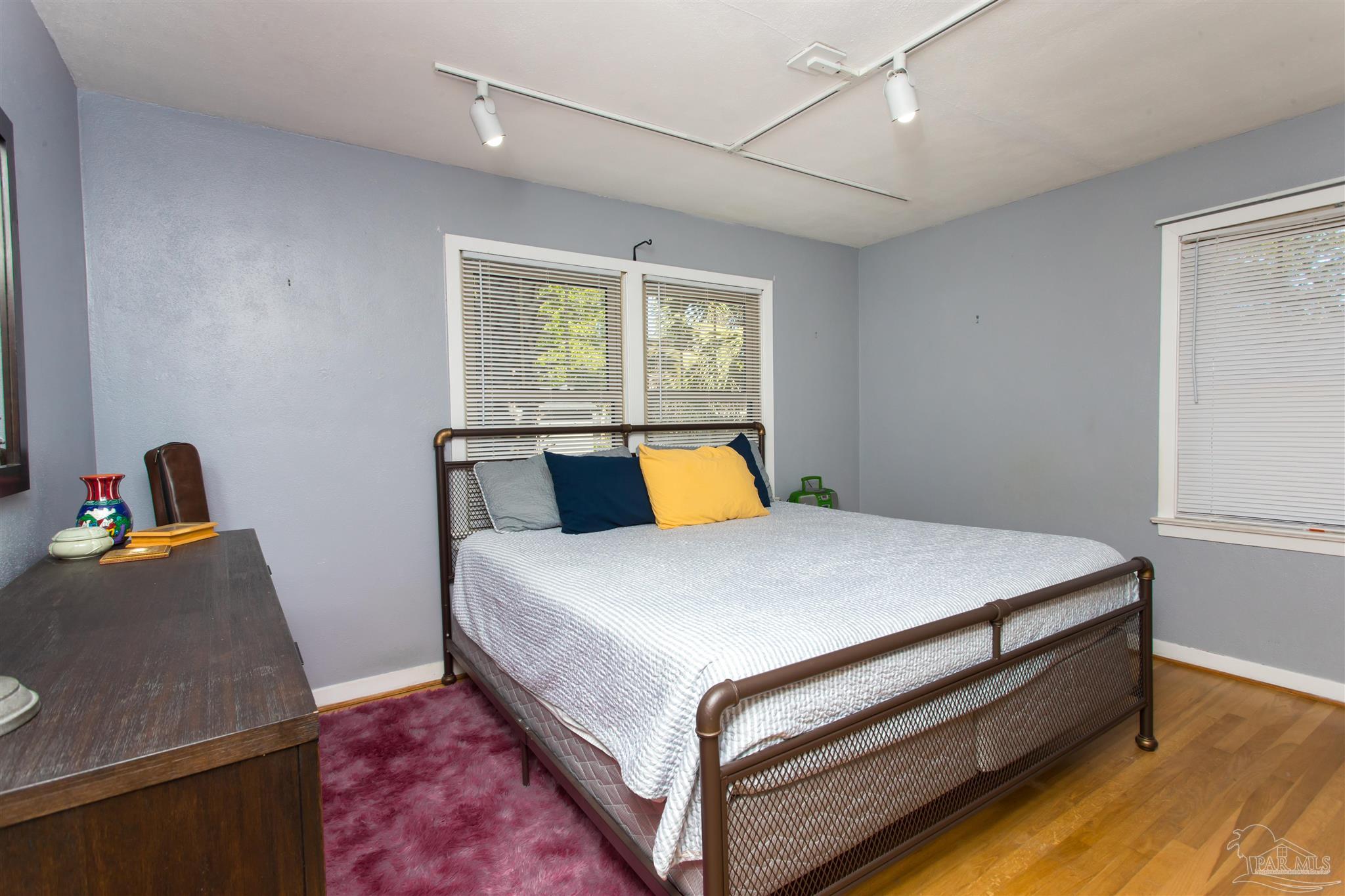 4415 Piedmont Road Pensacola, FL 32503 - Photo 18 of 43 a bed sitting in a bedroom next to a window