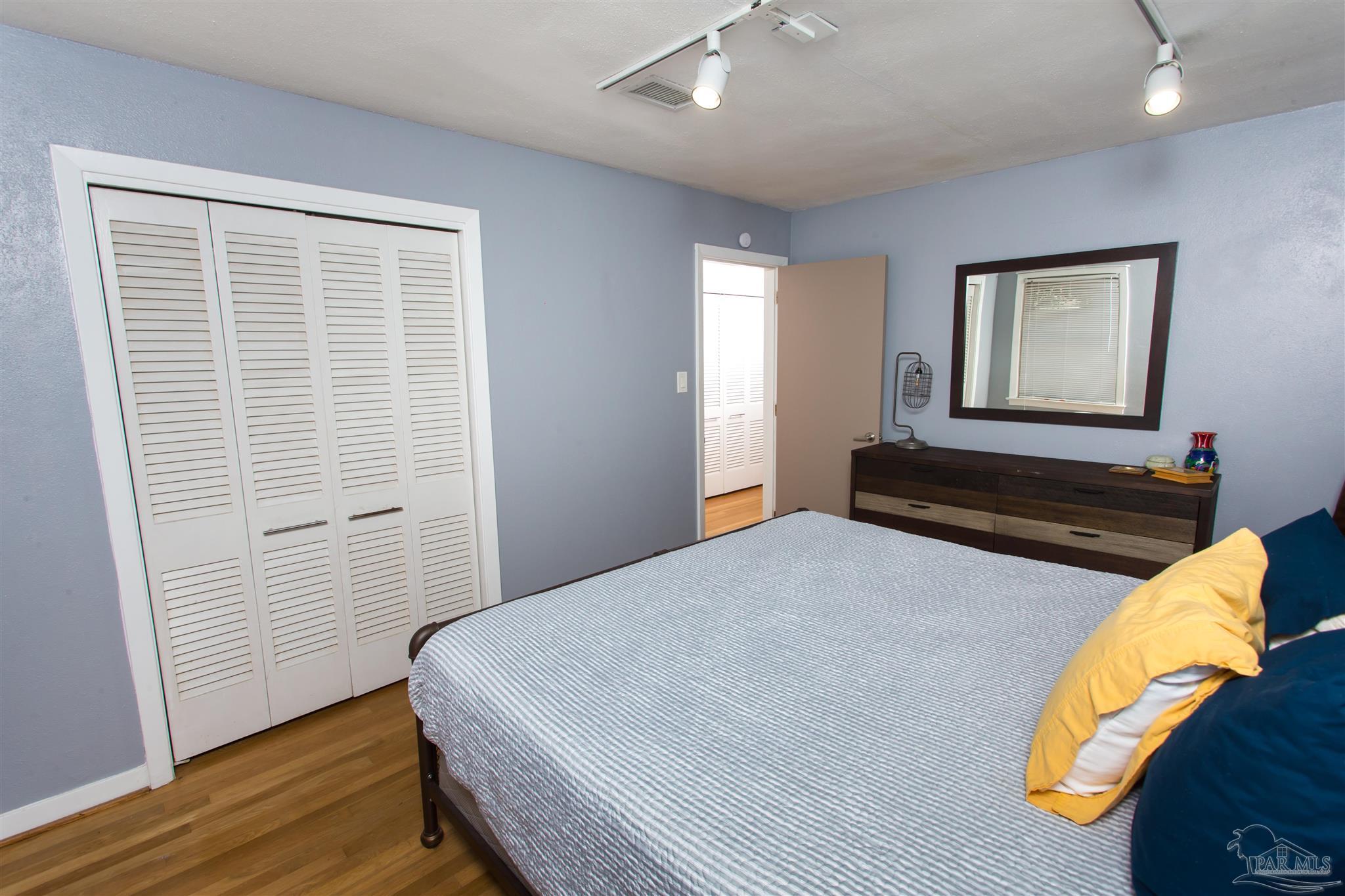 4415 Piedmont Road Pensacola, FL 32503 - Photo 19 of 43 a bedroom with a bed and wooden floor