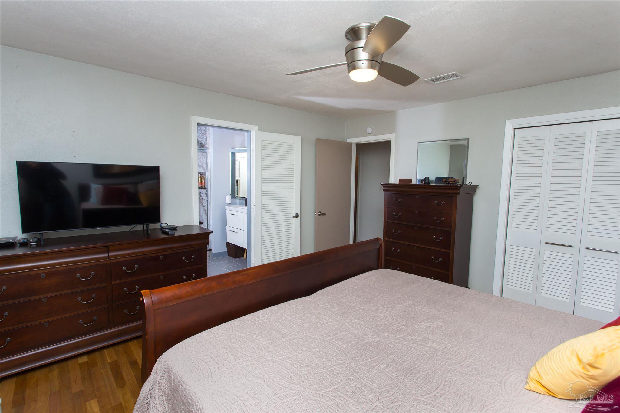 4415 Piedmont Road Pensacola, FL 32503 - Photo 25 of 43 a bedroom with a bed and a flat screen tv