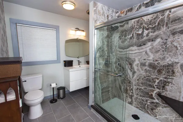 a bathroom with a toilet and a shower