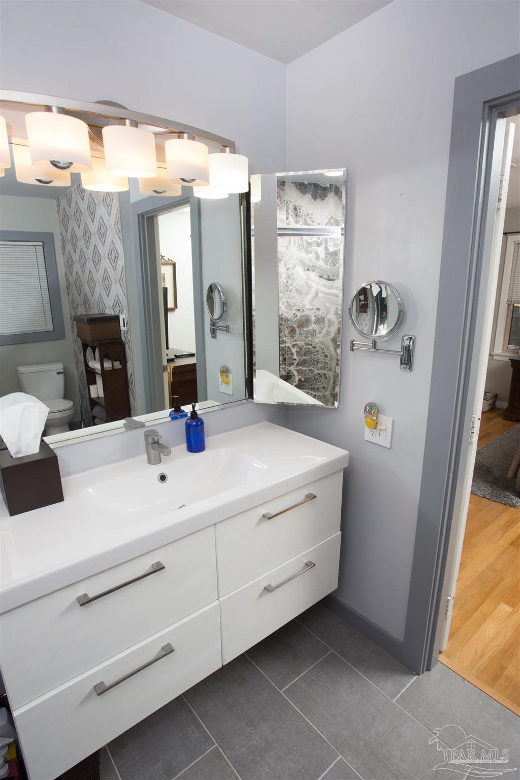 4415 Piedmont Road Pensacola, FL 32503 - Photo 27 of 43 a bathroom with a double vanity sink mirror and bathtub
