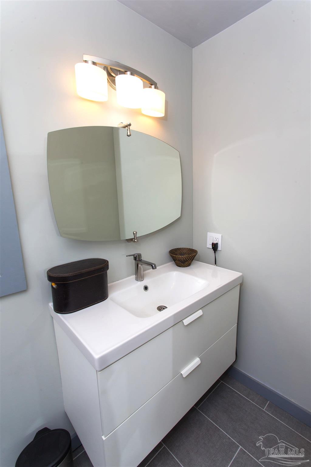 4415 Piedmont Road Pensacola, FL 32503 - Photo 28 of 43 a bathroom with a sink and a mirror