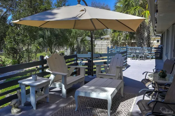 a view of a tables and chairs under an umbrella in patio