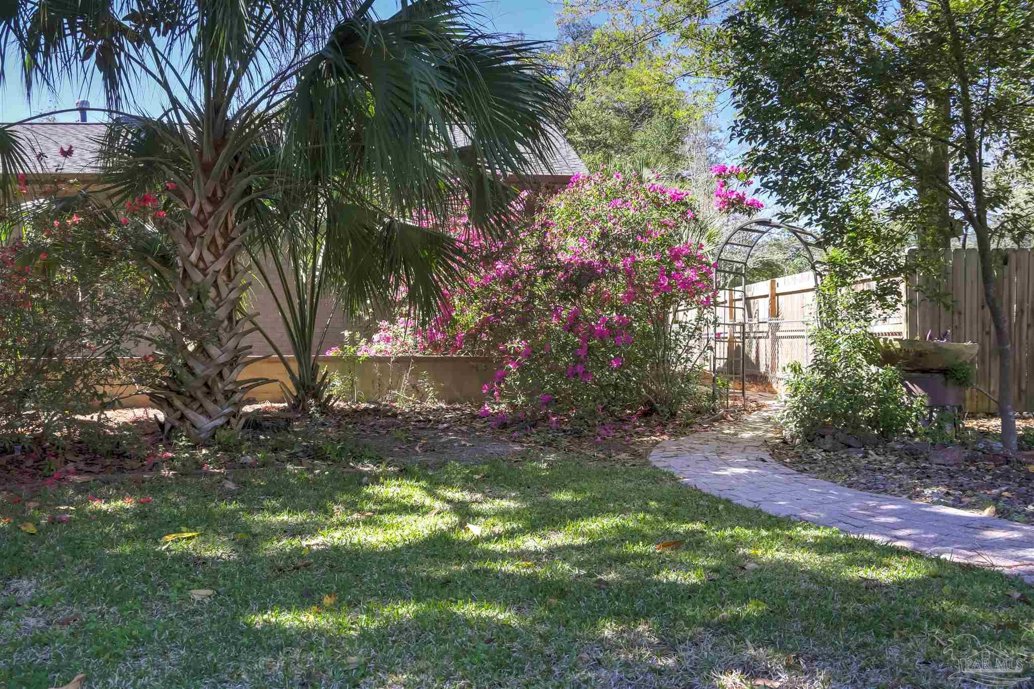 4415 Piedmont Road Pensacola, FL 32503 - Photo 34 of 43 a backyard of a house with lots of green space