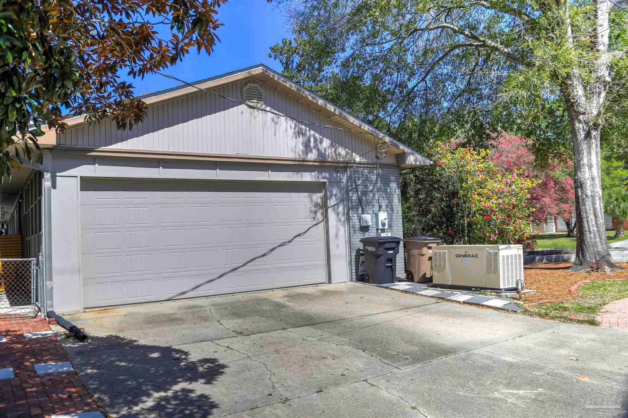 4415 Piedmont Road Pensacola, FL 32503 - Photo 40 of 43 a house with a yard and garage