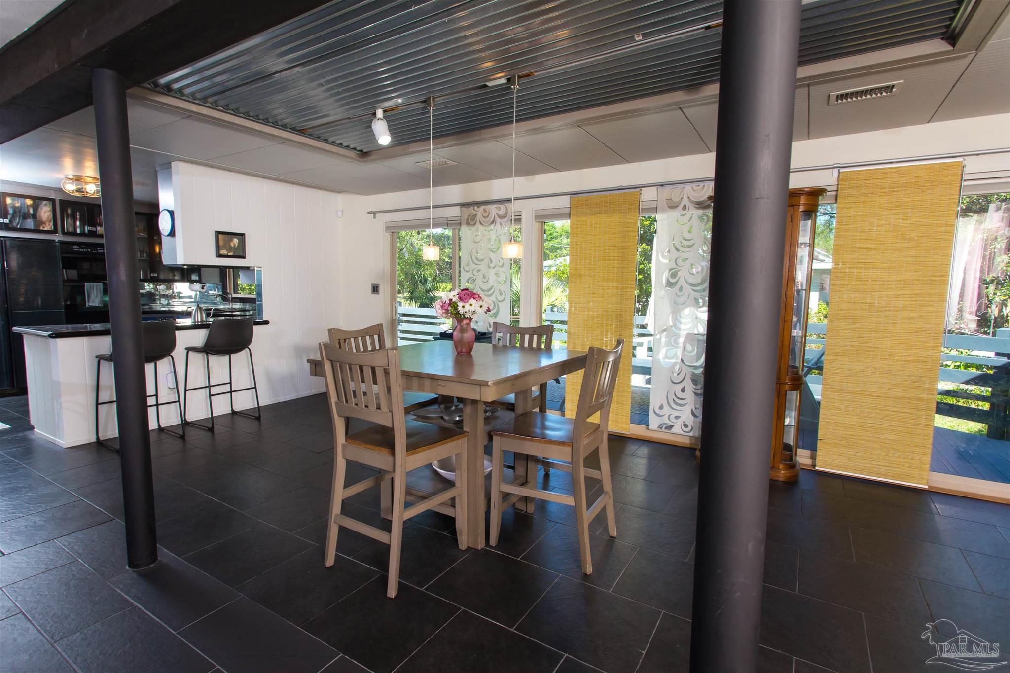 4415 Piedmont Road Pensacola, FL 32503 - Photo 6 of 43 a dining room with furniture window and wooden floor