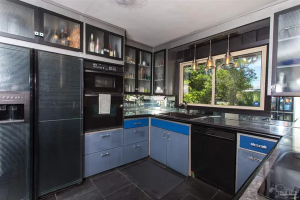 a kitchen with stainless steel appliances granite countertop a refrigerator and a sink