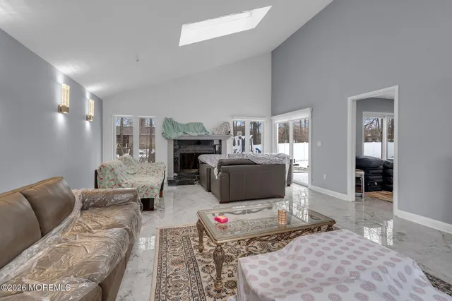 a living room with furniture and view of kitchen