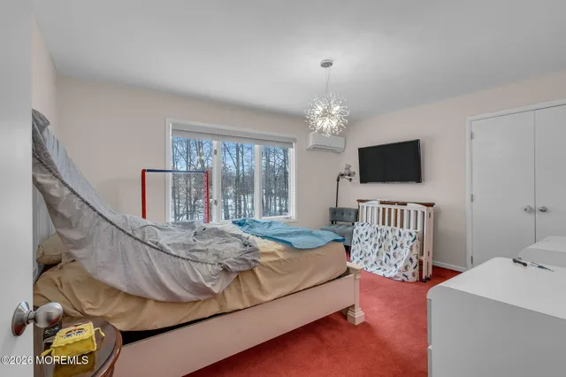 a bedroom with a bed and flat screen tv
