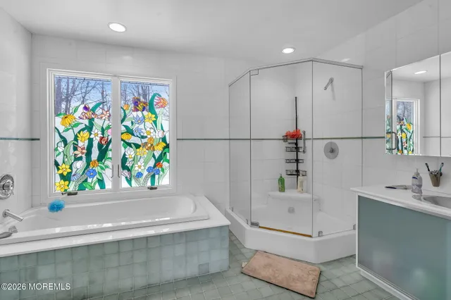 a bathroom with a sink a vanity and a shower