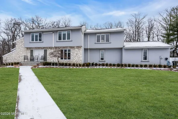 a front view of house with yard and green space