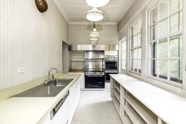 a large kitchen with a stove and a sink