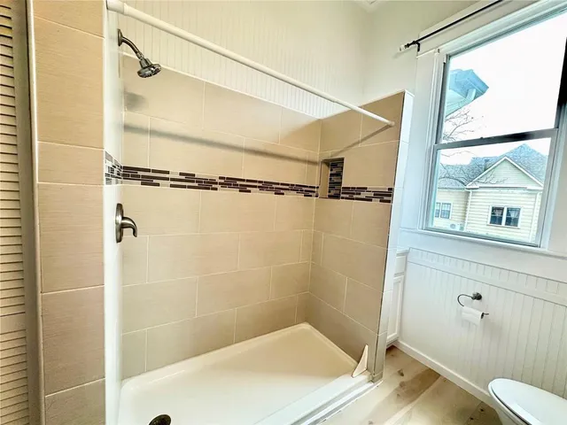 a bathroom with a shower and a window