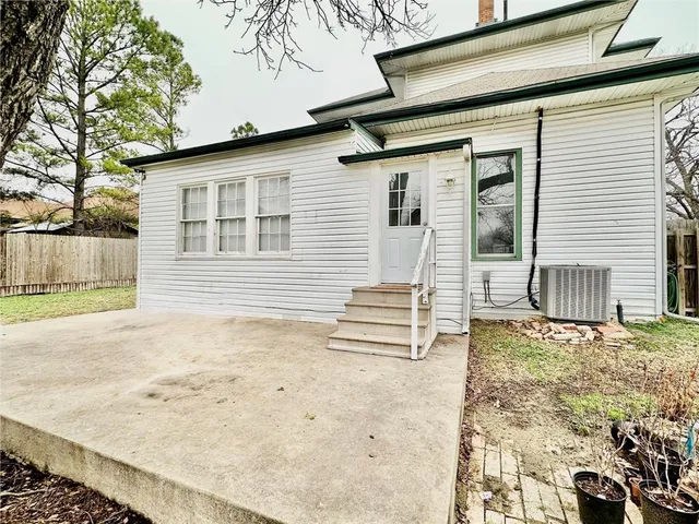 a view of a house with a wooden fence