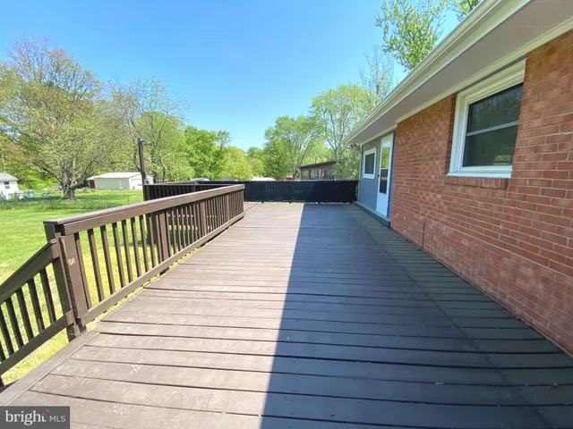 a view of balcony with wooden floor and fence